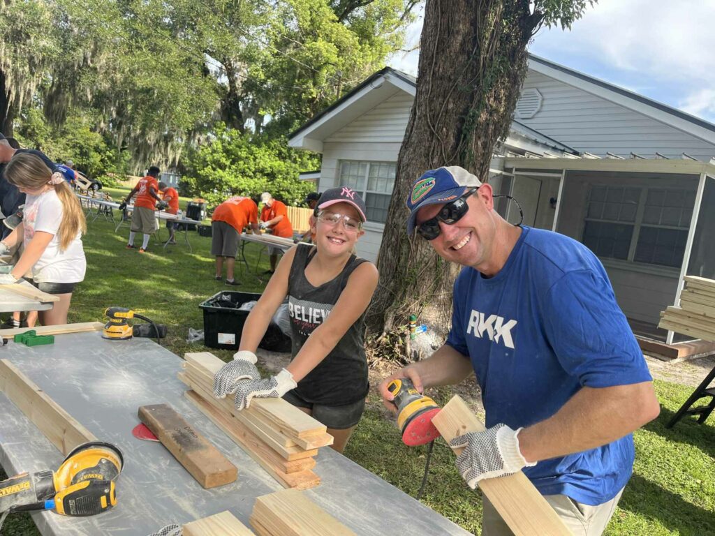 a father and daughter working with some boards