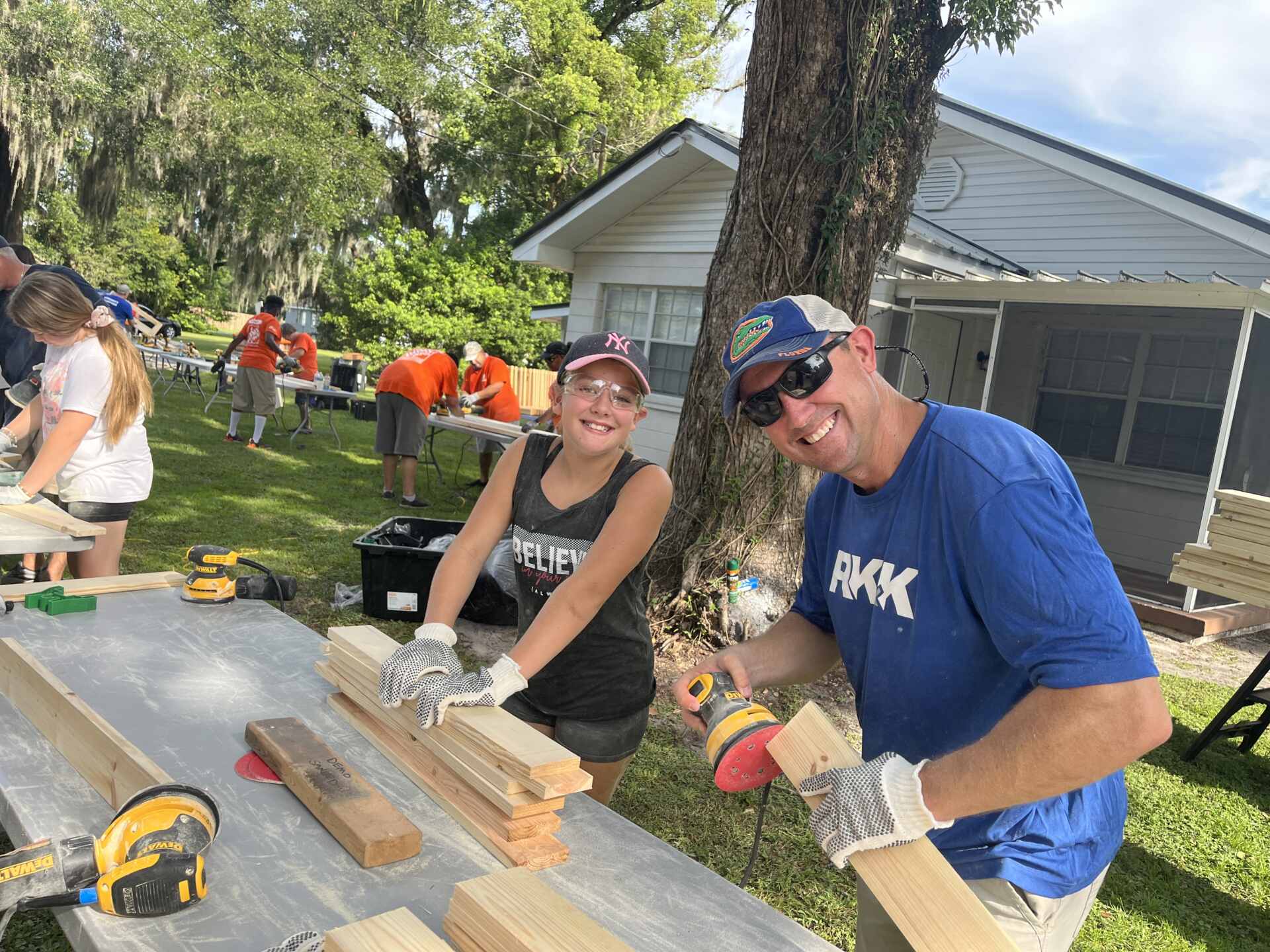 a father and daughter working with some boards