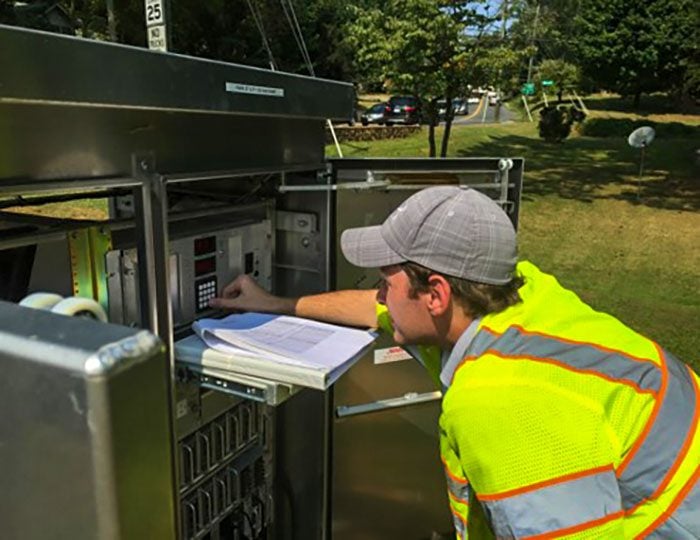 Brian Grandizio working on a signal timing cabinet