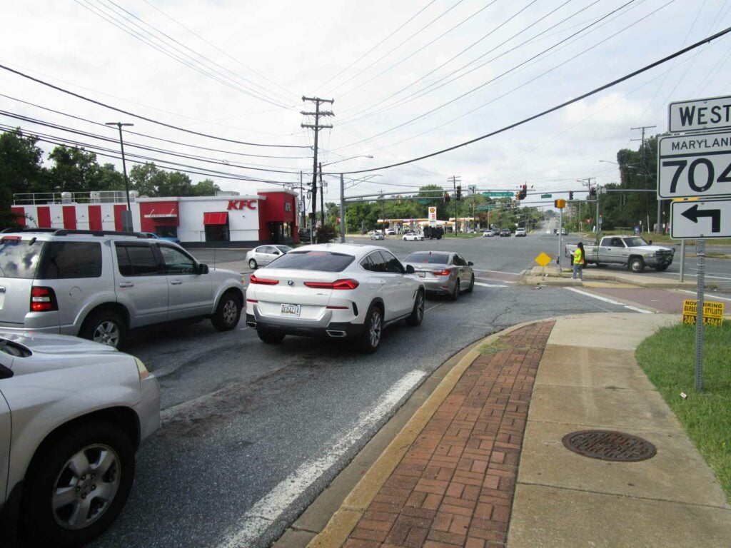 Kayla Cash examines a pedestrian crossing