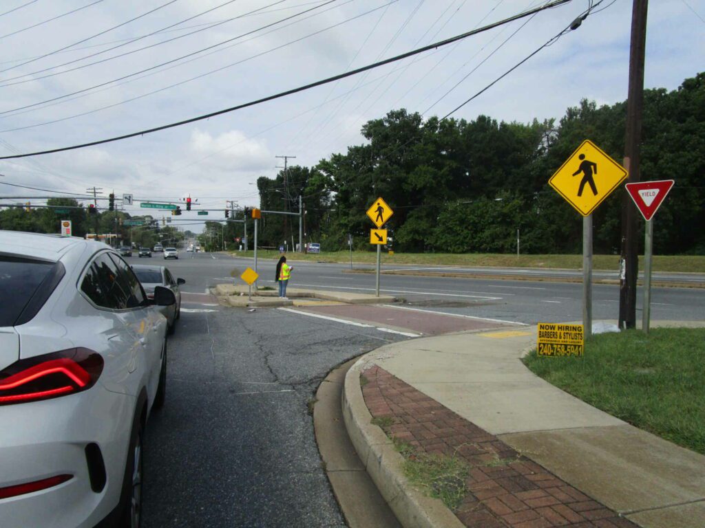 Kayla Cash examines a pedestrian crossing