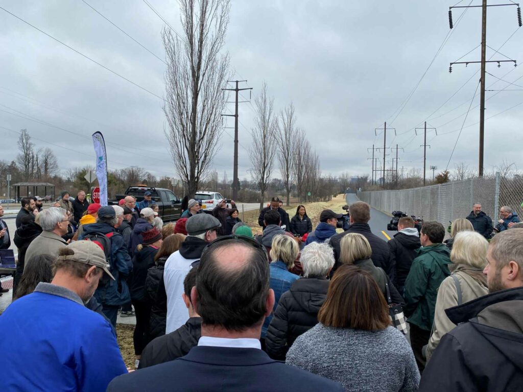 A group watches he ribbon cutting for Chester Valley Trail.