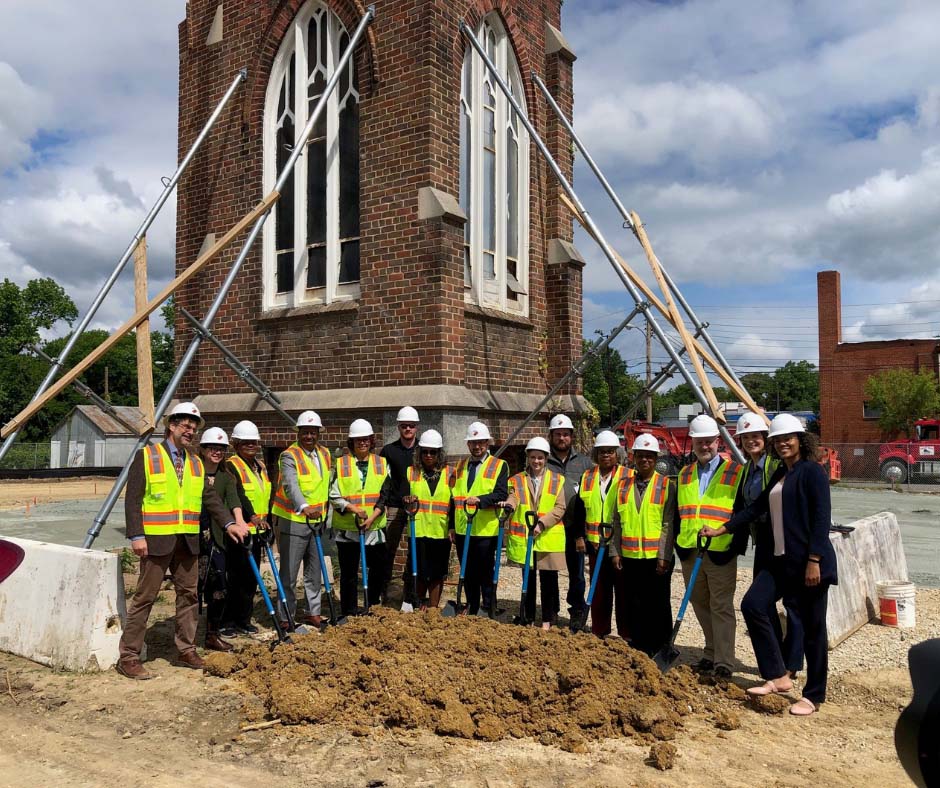 a crew celebrating groundbreaking for brookland apartments