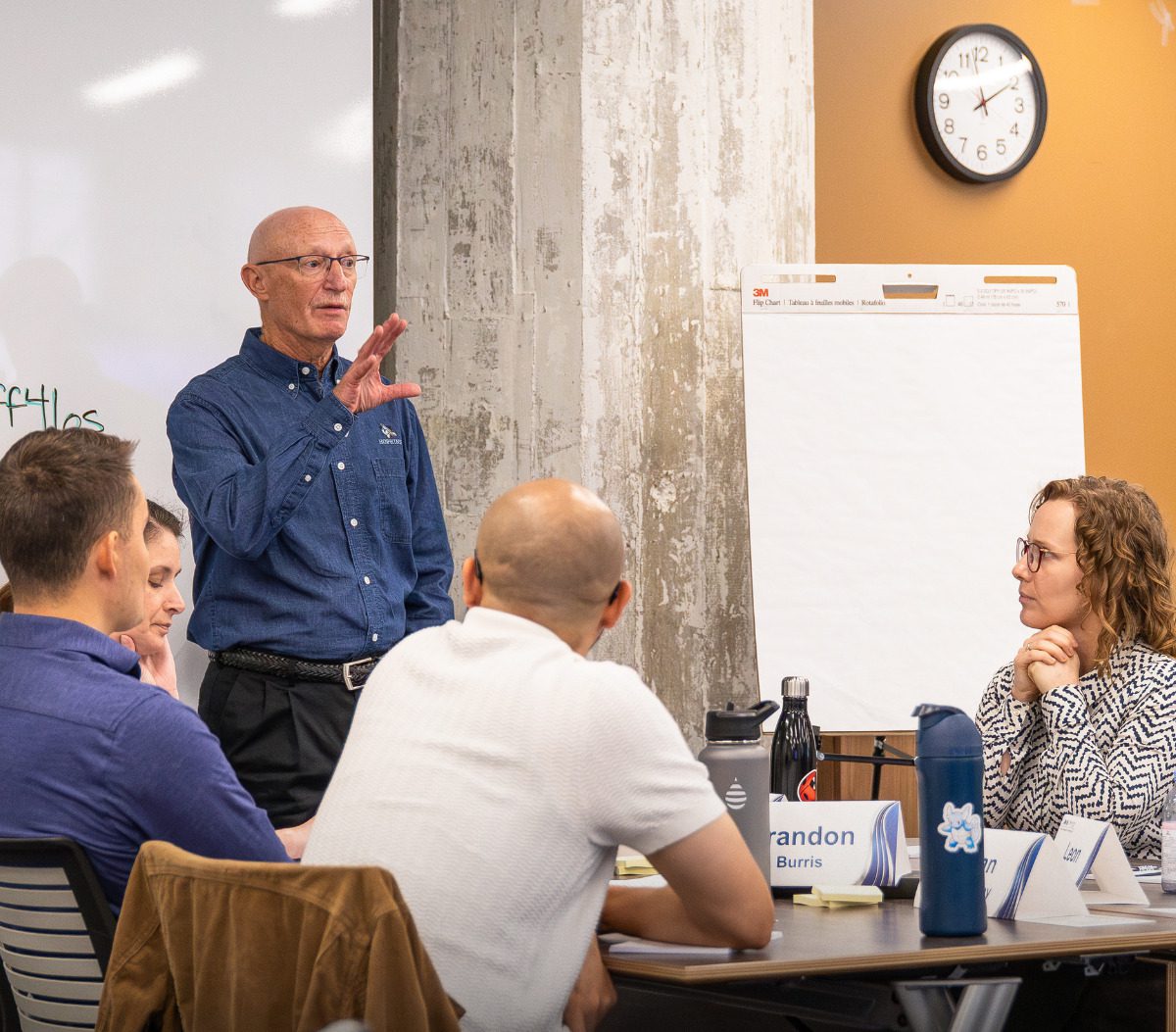 An instructor telling students about the project.