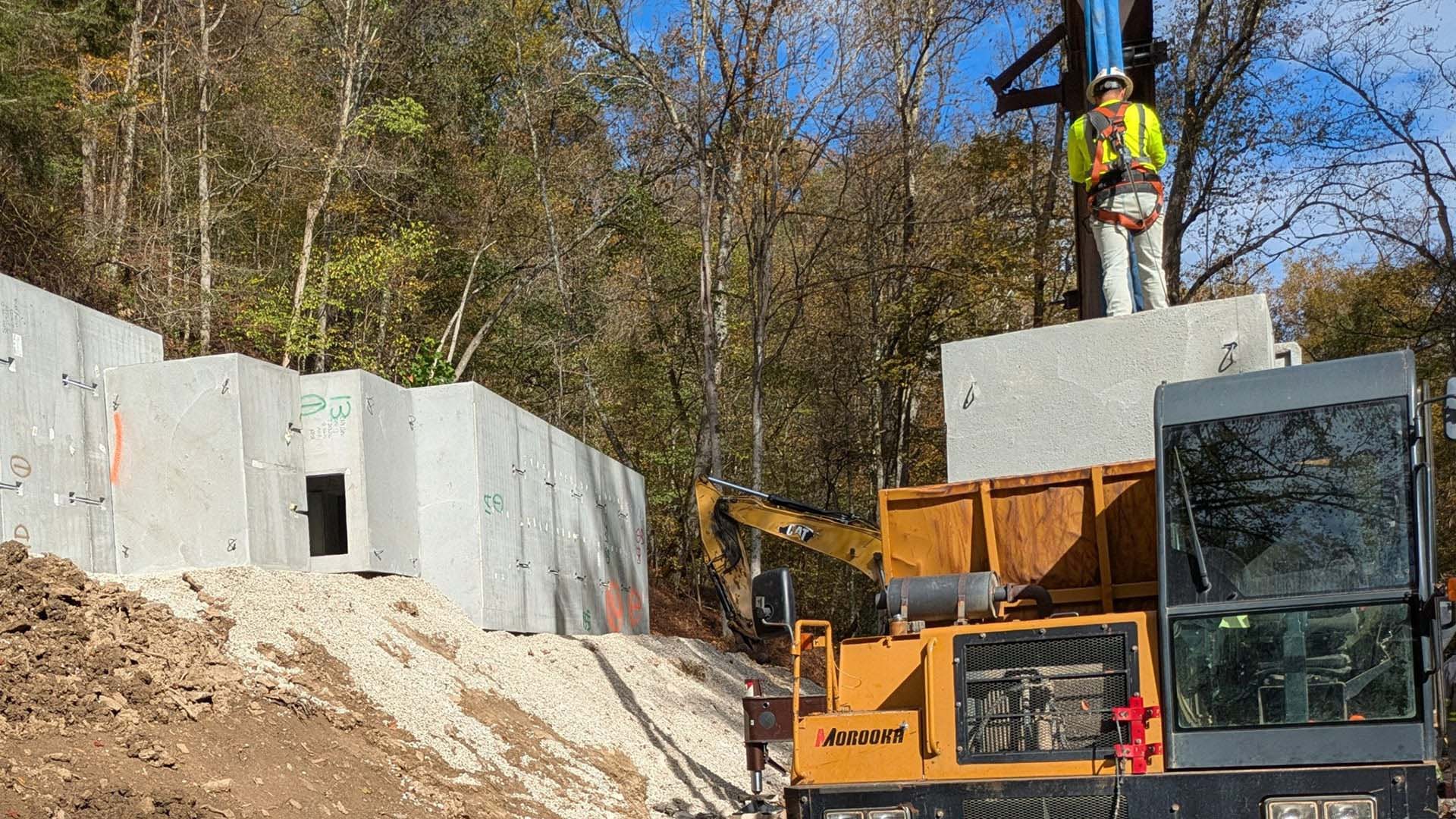 Construction of a bat hibernaculum using precast concrete chambers and heavy equipment.